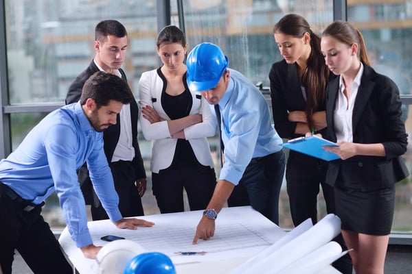 business people group on meeting and presentation  in bright modern office with construction engineer architect and worker looking building model and blueprint planbleprint plans